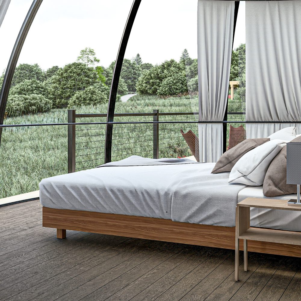 King bed inside an Alaskan glamping dome with panoramic views
